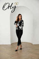 Black slim jeans with sparkling embellished ankle cuff, styled with heels