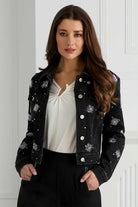 . Front view of Orly black jean jacket with crystal starburst embellishments
