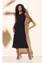 Model wearing Alison Sheri black sleeveless knit sweater dress with scalloped hemline and chic midi length