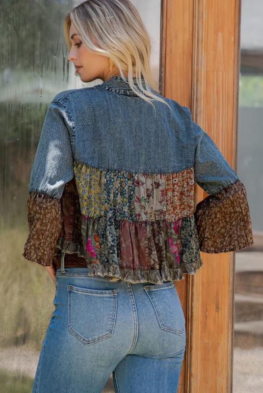 Woman wearing a patchwork denim jacket with a blurred background, backview