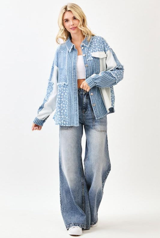 Woman wearing a blue denim jacket and jeans on a white background