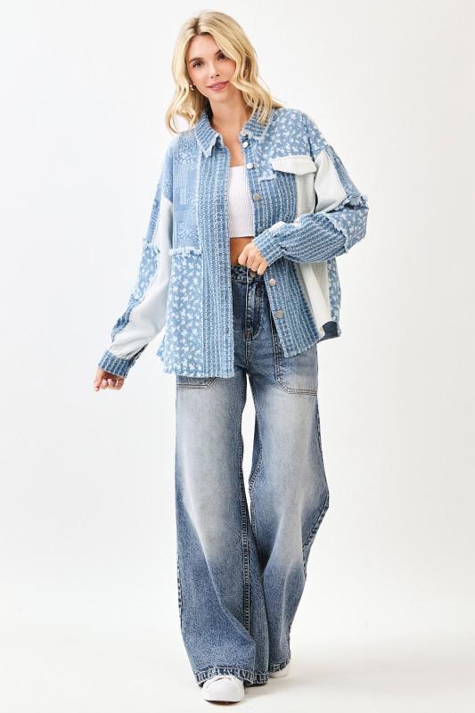 Woman wearing a blue denim jacket and jeans on a white background