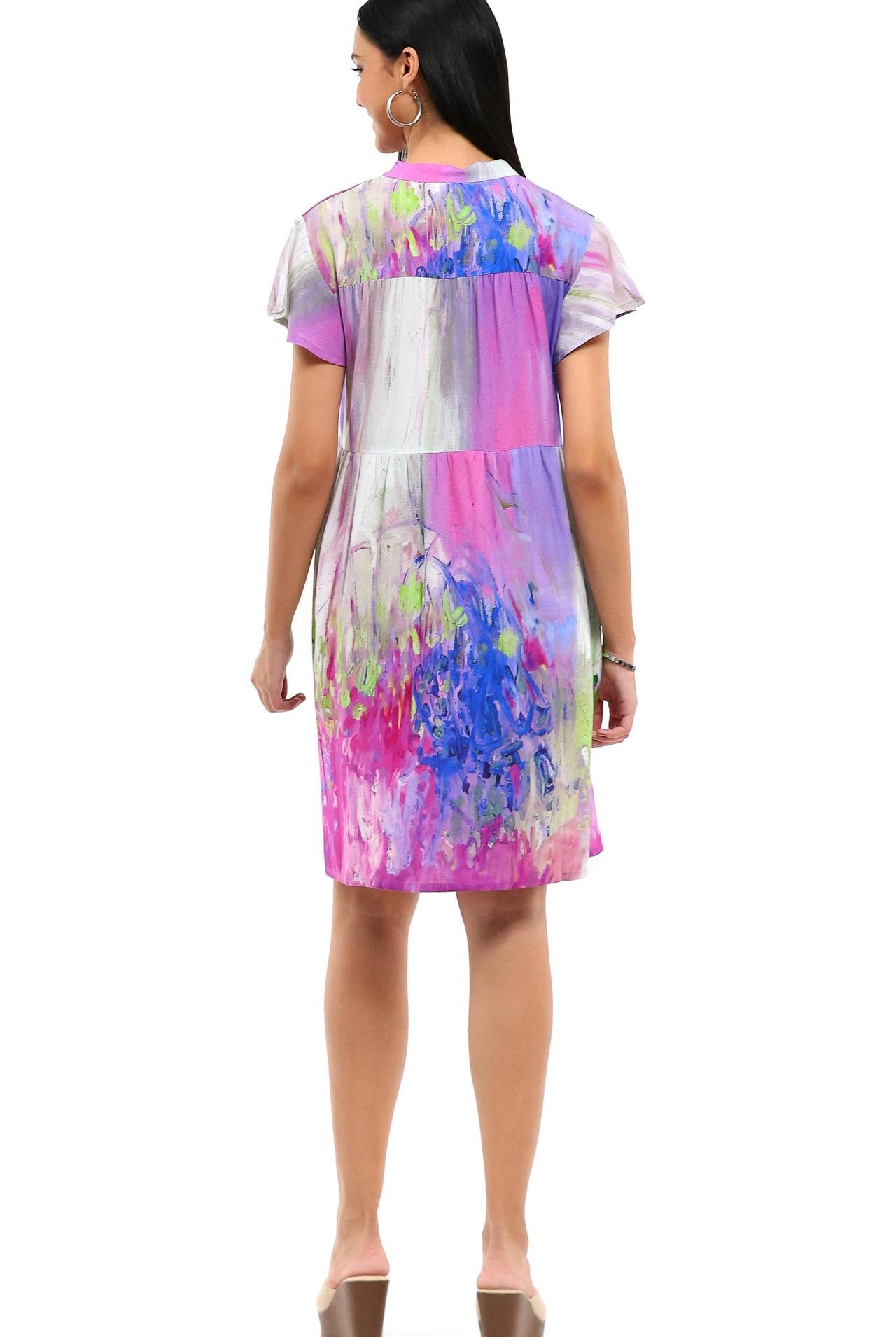 Parsley & Sage watercolor rayon dress with flutter sleeves worn by resort chic model, back view