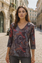 Beautiful urban chic woman wearing abstract print V-neck top