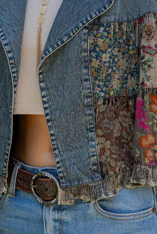 Patchwork denim jacket with floral patterns and a belt closeup
