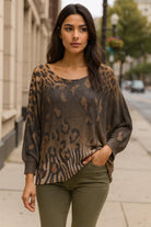 Beautiful urban chic woman wearing a Made in Italy dolman sleeve animal print sweater with khaki green pants.