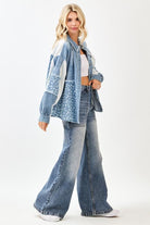 Woman wearing a denim outfit with a white background, side view