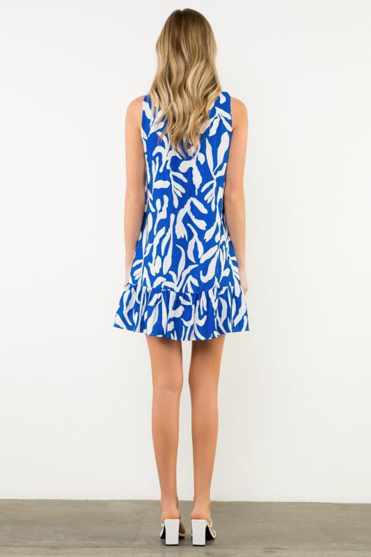 Woman wearing a blue and white patterned dress , Back View