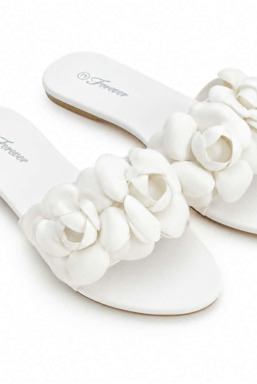 Forever women’s white flat slide sandals with dimensional floral embellishments and open-toe slip-on design.