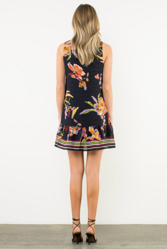 Woman wearing a floral dress with a white background, Back View
