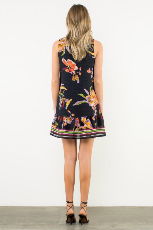 Woman wearing a floral dress with a white background, Back View