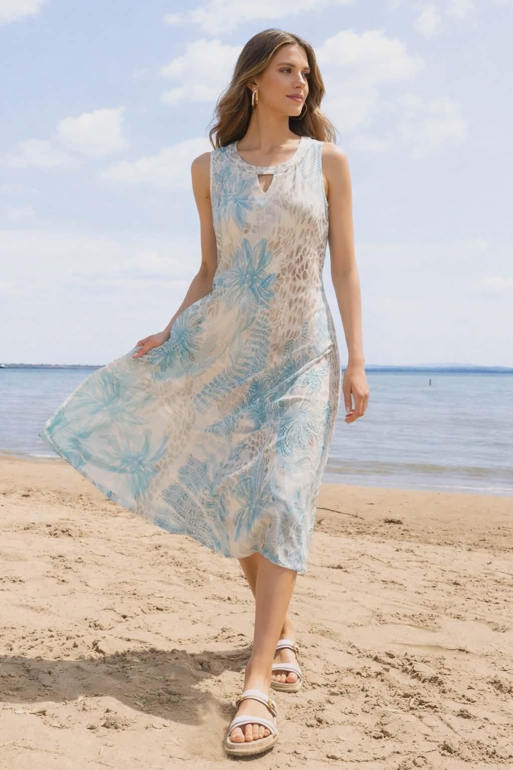 Alison Sheri blue tropical floral sleeveless midi dress with keyhole neckline worn on beach