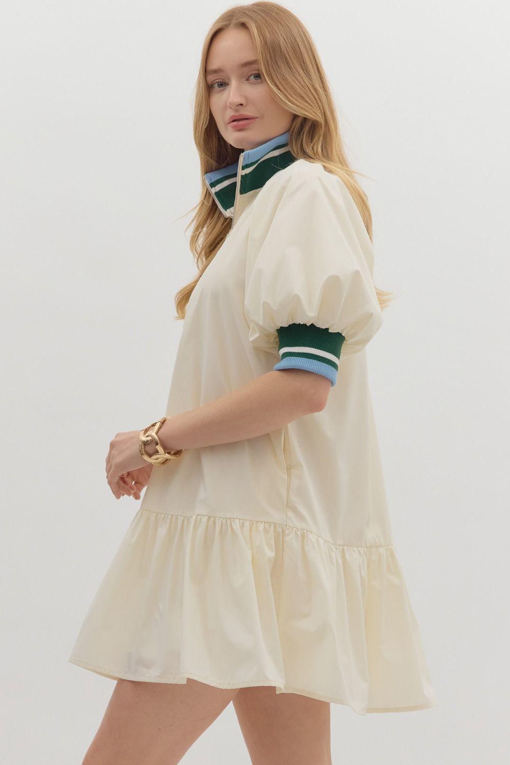 Sporty chic cream half-zip dress with puff sleeves and contrast striped collar side view