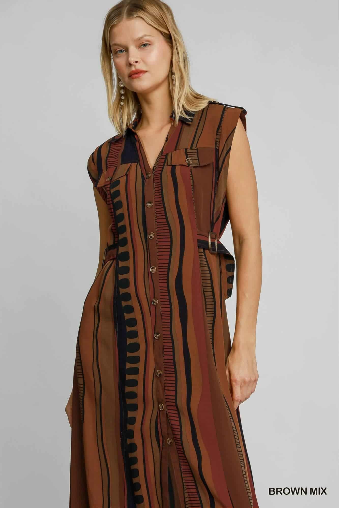 Woman wearing a patterned dress with a brown mix color on a gray background