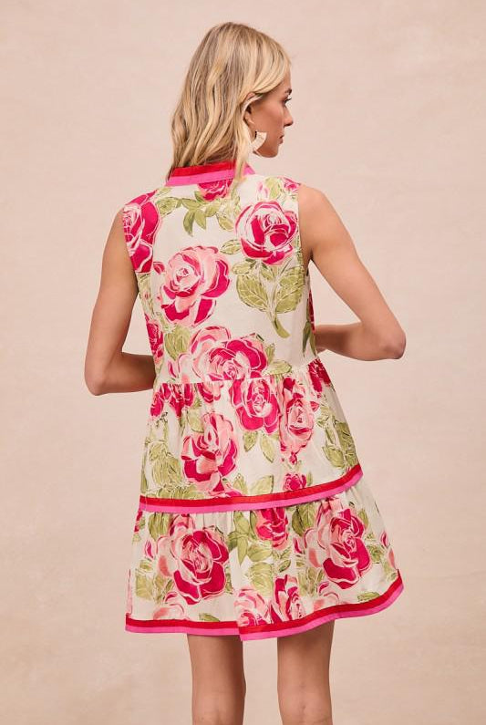 Woman wearing a floral dress with pink roses on a beige background, BACK VIEW