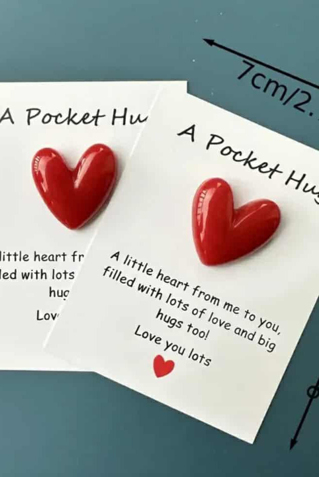 Pocket Hug card with attached red heart token, displayed flat.