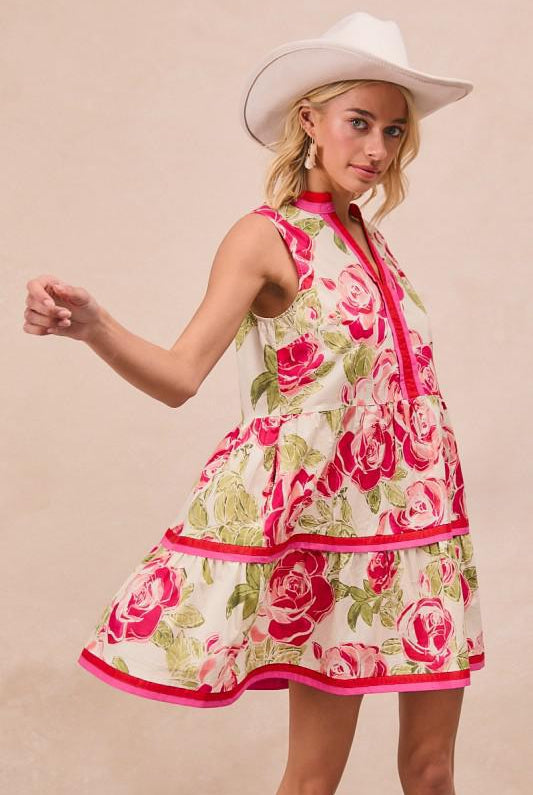 Woman wearing a floral dress with pink roses and a white cowboy hat on a beige background
