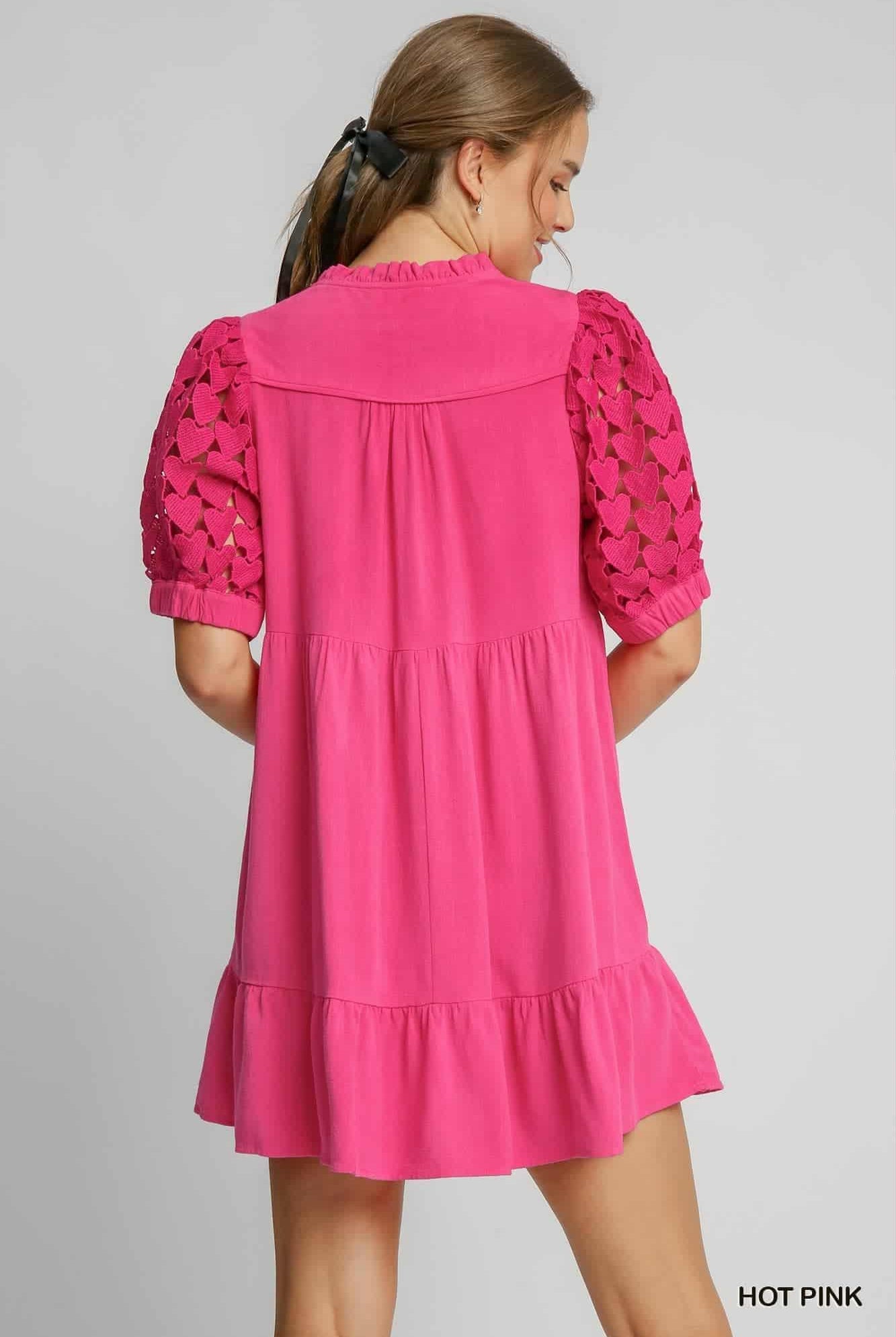 Pink dress with lace sleeves on a gray background, back view