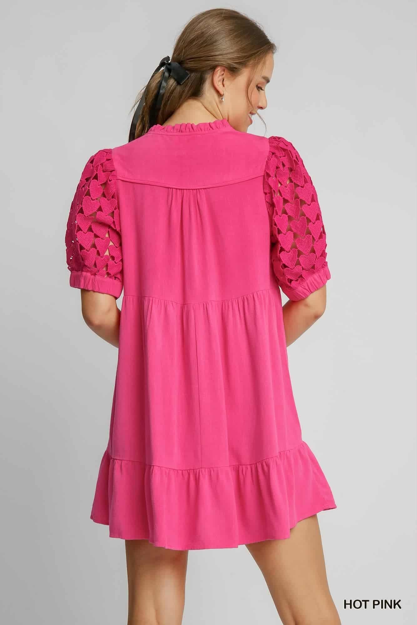 Pink dress with lace sleeves on a gray background, back view