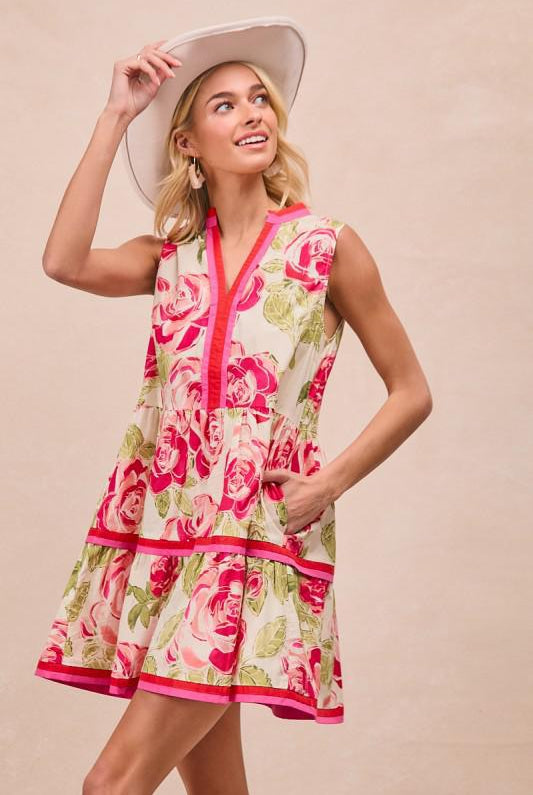 Woman wearing a floral dress and hat on a beige background