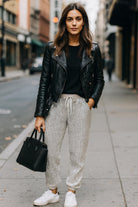 Urban chic sequin jogger pants with drawstring waist and tapered ankle cuffs, styled for casual glamour or evening wear