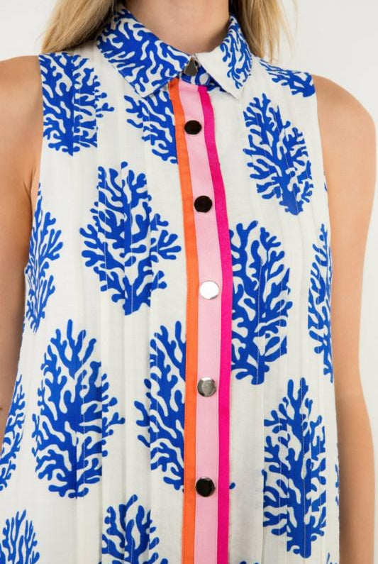 Sleeveless dress with blue coral pattern and colorful buttons, closeup