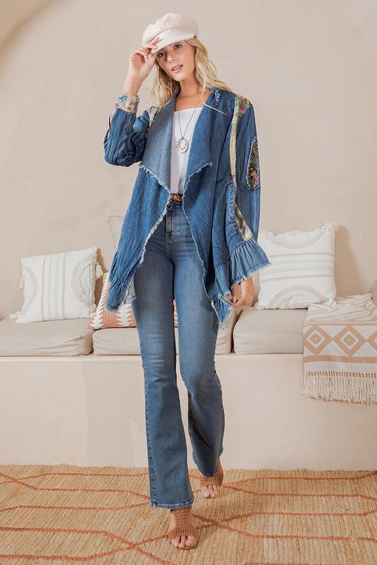 Woman wearing a denim jacket and jeans in a living room setting