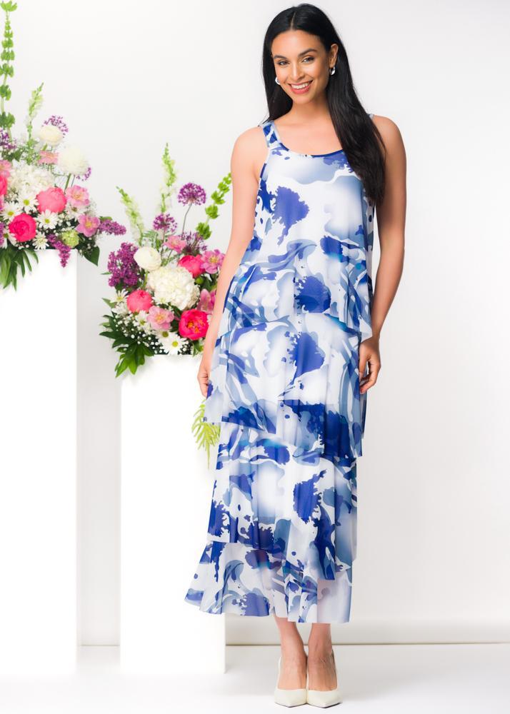 Model wearing Elena Wang blue watercolor mesh tiered maxi dress with sleeveless silhouette styled for elegant resort occasion