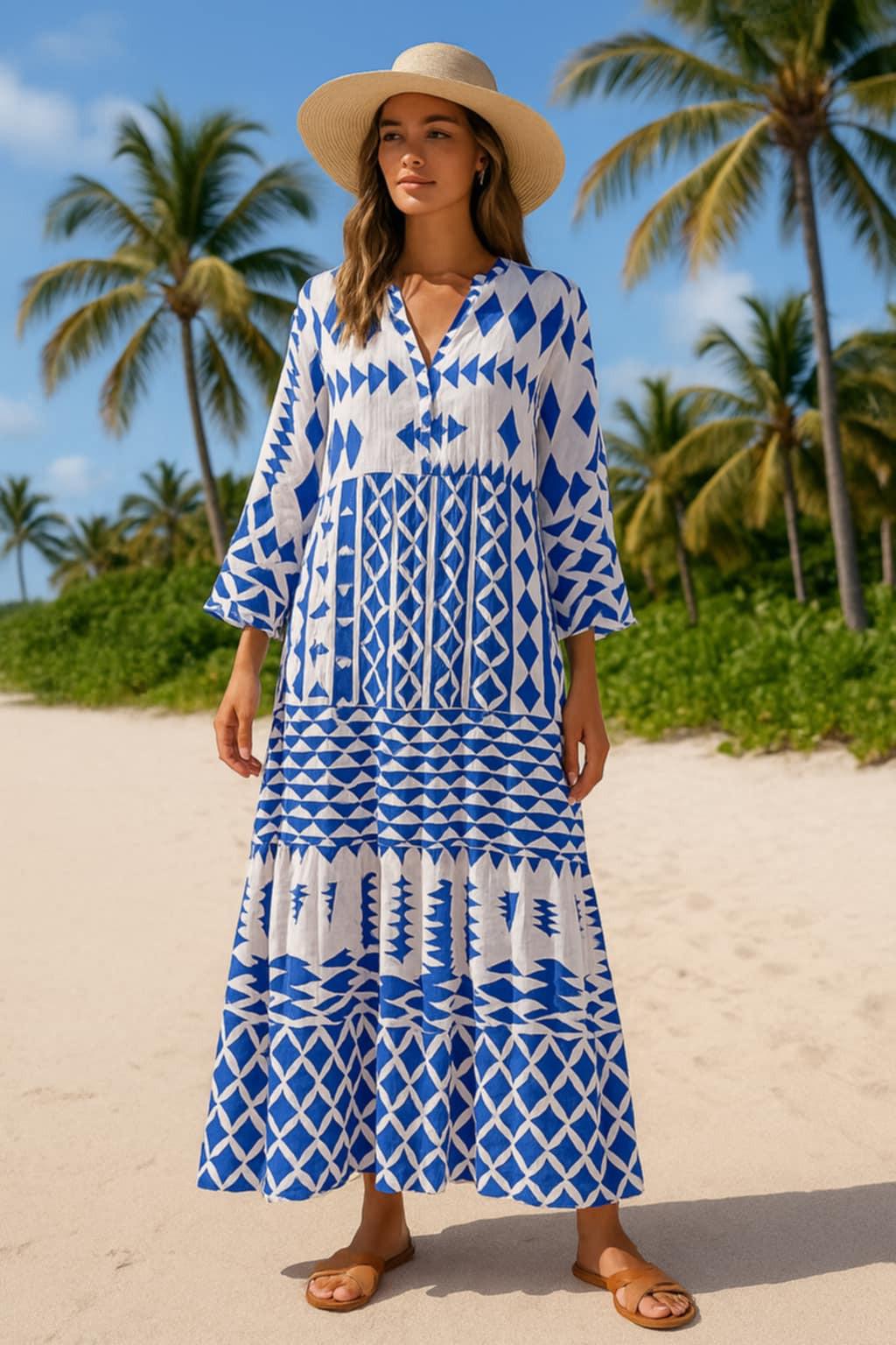 Resort chic woman wearing blue and white long sleeve maxi dress with flowing hem