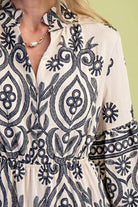 Close-up of a person wearing a patterned dress with a green background