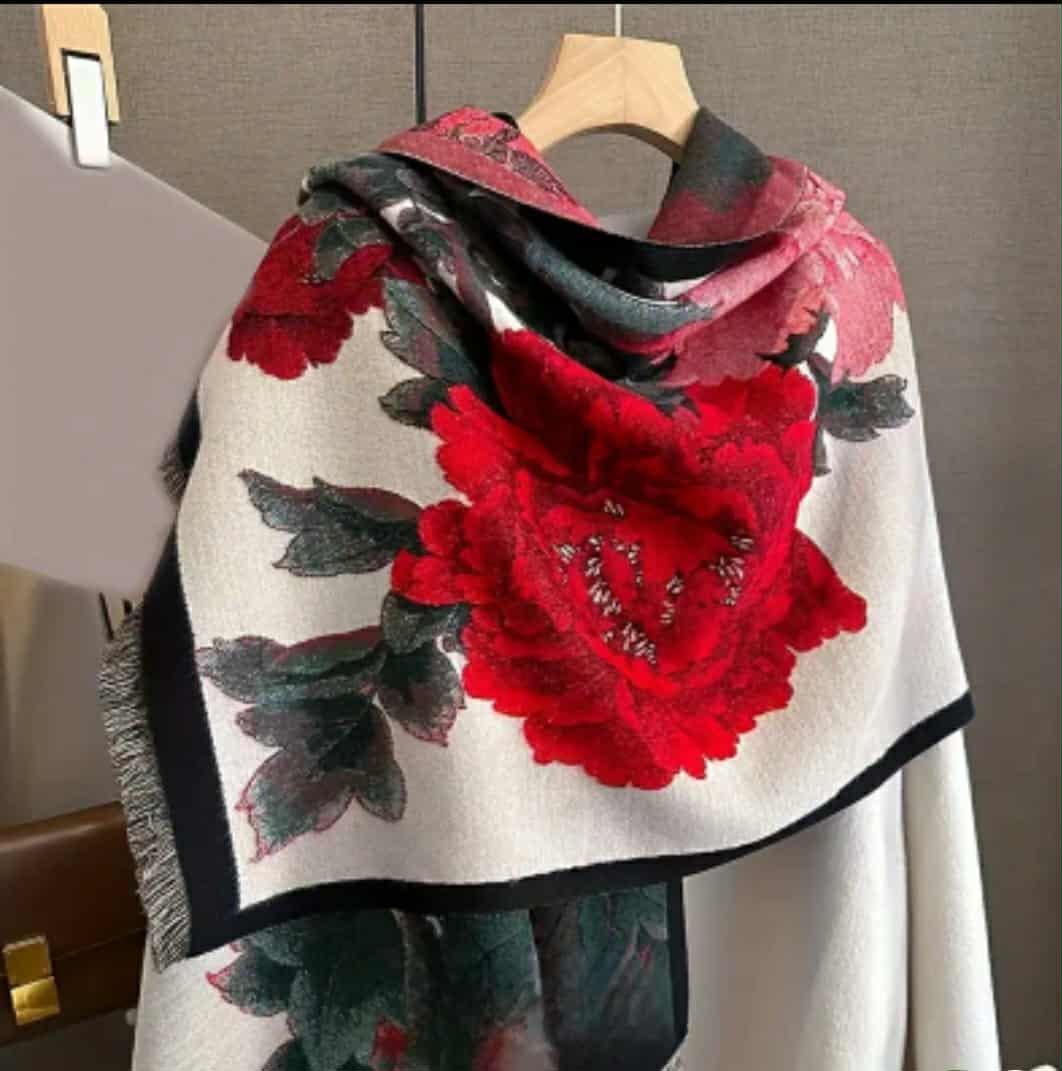 “Red floral jacquard wrap displayed on hanger with peony print”