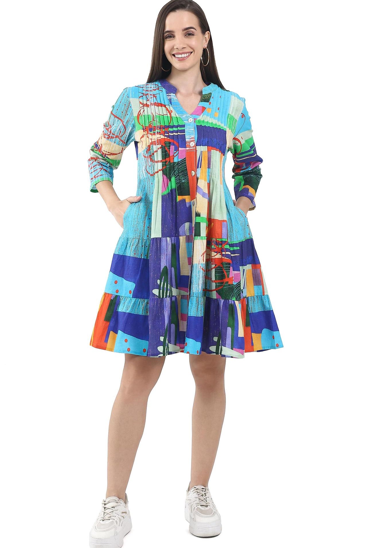 Woman wearing a colorful patterned dress on a white background