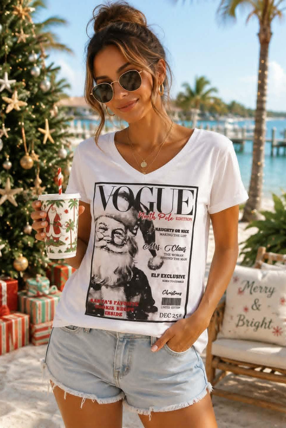 Women's white V-neck Christmas graphic tee featuring a vintage-inspired VOGUE North Pole Edition Santa Claus print, perfect for festive holiday styling.