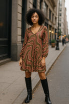 Urban chic girl wearing swirl print tunic dress with ankle boots