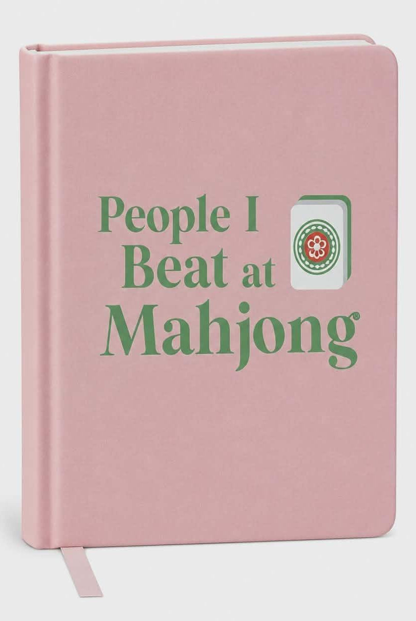 Blush pink hardcover blank journal with the phrase "People I Beat at Mahjong®" and a Mahjong tile illustration.