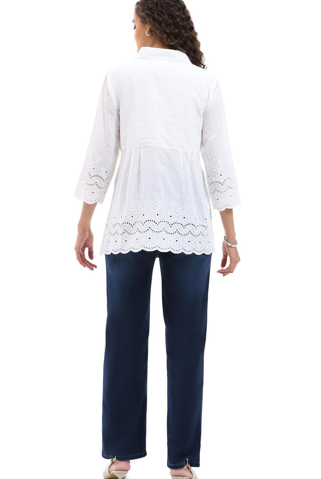 Woman wearing a Parsley & Sage white lace-trimmed top and navy pants on a white background, back view