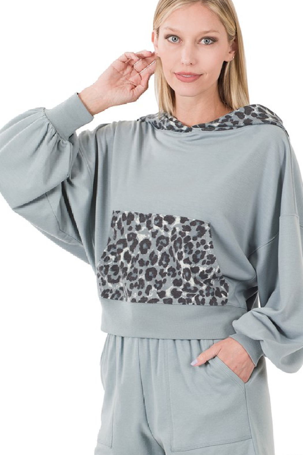 women in a gray hoodie featuring leopard print hood lining and kangaroo pocket.