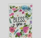 Small floral pocket tissue pack with colorful flowers and "Bless You" text, perfect for purses, travel, and gift giving.