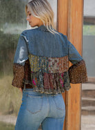 Woman wearing a patchwork denim jacket with a blurred background, backview