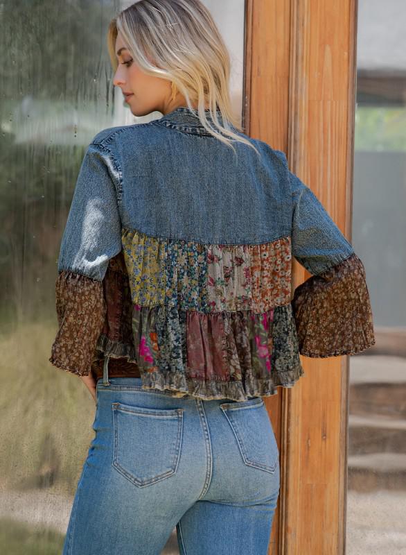Woman wearing a patchwork denim jacket with a blurred background, backview