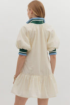 Sporty chic cream half-zip dress with puff sleeves and contrast striped collar, back view