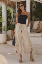 Gabby Isabella beige wide leg cropped pants with drawstring waist and side ruched slit detail styled for a resort chic look