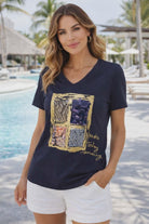 Michael Tyler navy V-neck tee with sequin square graphic and “Make Today Amazing” gold script on a resort-chic model