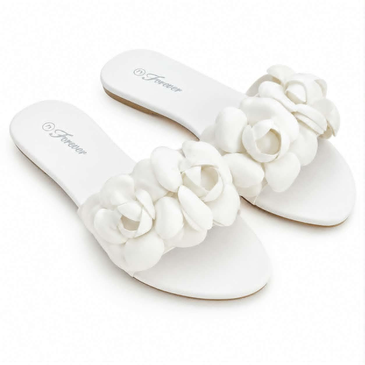 Forever women’s white flat slide sandals with dimensional floral embellishments and open-toe slip-on design.

