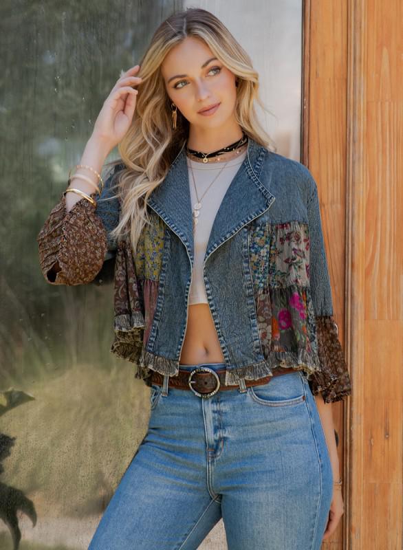 Woman wearing boho patchwork denim jacket with floral sleeves and ruffle cuffs from Petunias of Naples