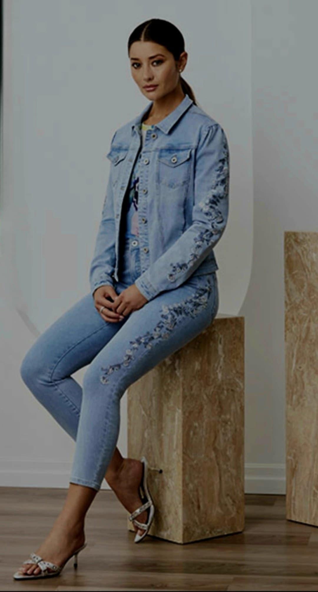 Light wash Orly denim jacket with floral embroidery and sparkling crystal embellishments on sleeves.