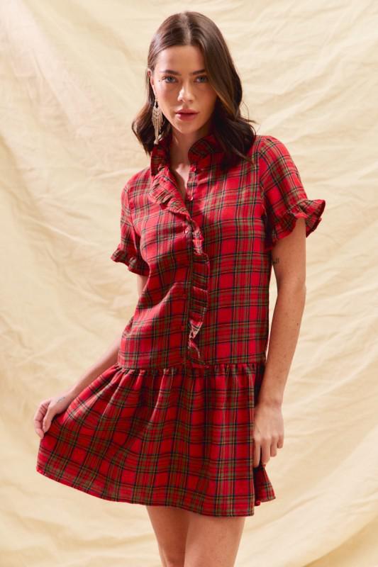 Woman wearing a red plaid ruffle mini dress with button front and flounce hem