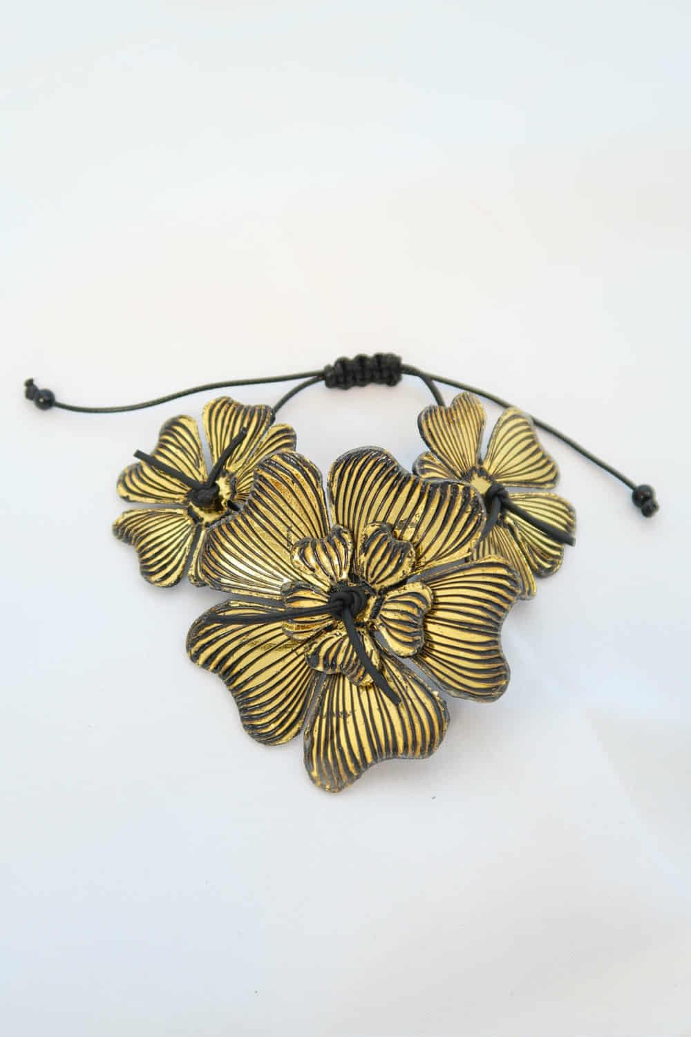 Gold floral BRACELET MADE FROM RECYCLED WATER BOTTLES on a white background