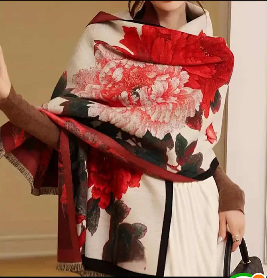 “Model wearing red and white floral jacquard shawl elegantly draped”