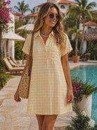 Yellow gingham short sleeve shirt dress with button front and relaxed boxy fit, styled for a resort chic look by the pool
